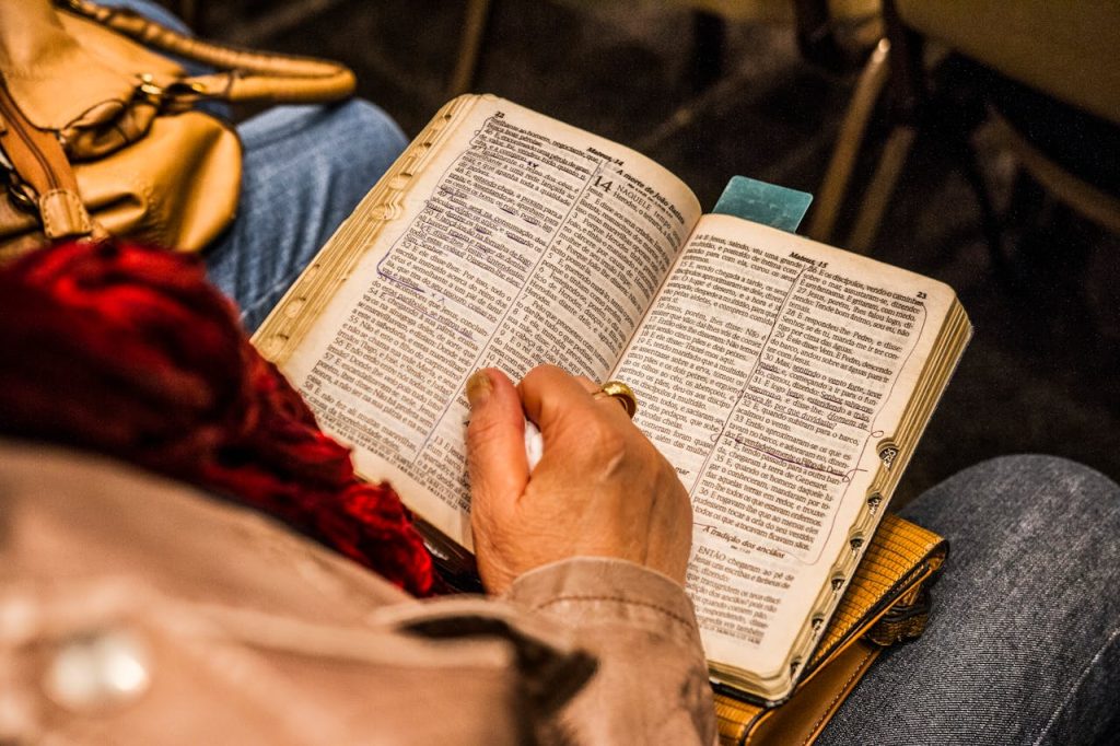pexels-photo-1296720 Person Holding Opened Book